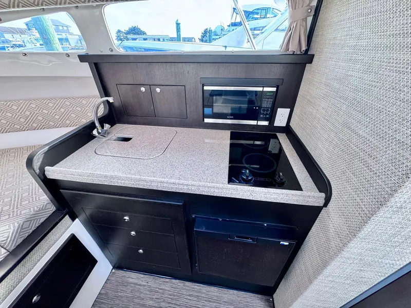 Slide: The Image of 2022 Stamas 370 Aegean yacht interior kitchen with sink, stove, and microwave. - 9