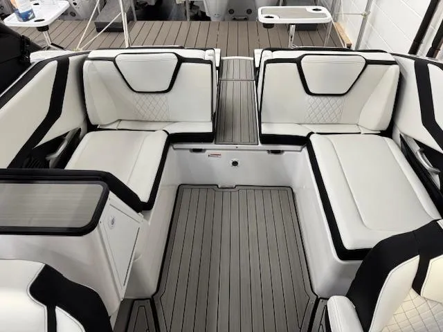Slide: The Image of 2025 Yamaha Boats 252SD interior with sleek white seating and modern design. - 12
