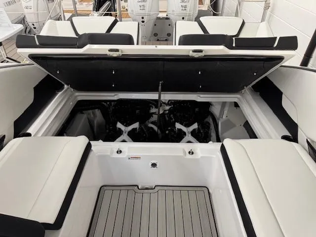 Slide: The Image of 2025 Yamaha Boats 252SD engine compartment with open hatch, showcasing dual engines and seating area. - 16