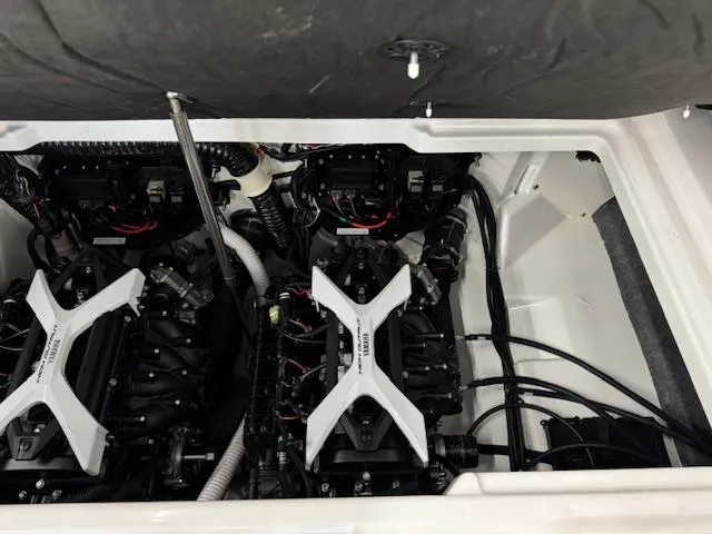 Slide: The Image of Engine compartment of a 2025 Yamaha Boats 252SD, showcasing dual engines and mechanical components. - 18