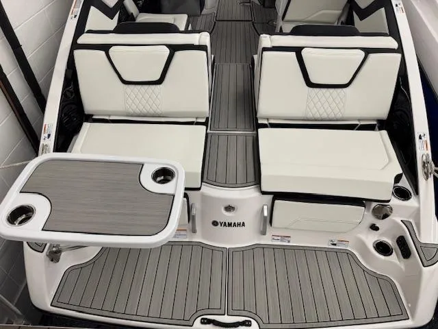 Slide: The Image of 2025 Yamaha Boats 252SD interior with sleek seating and table setup. - 23