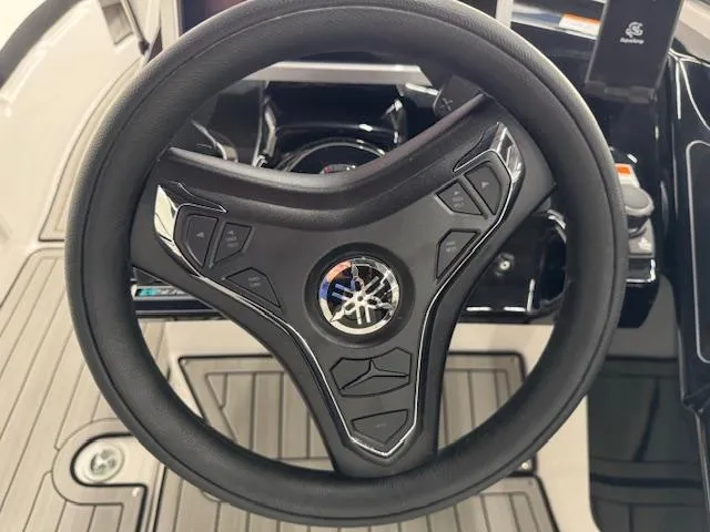Slide: The Image of Steering wheel of 2025 Yamaha Boats 252SD, featuring modern controls and sleek design. - 7