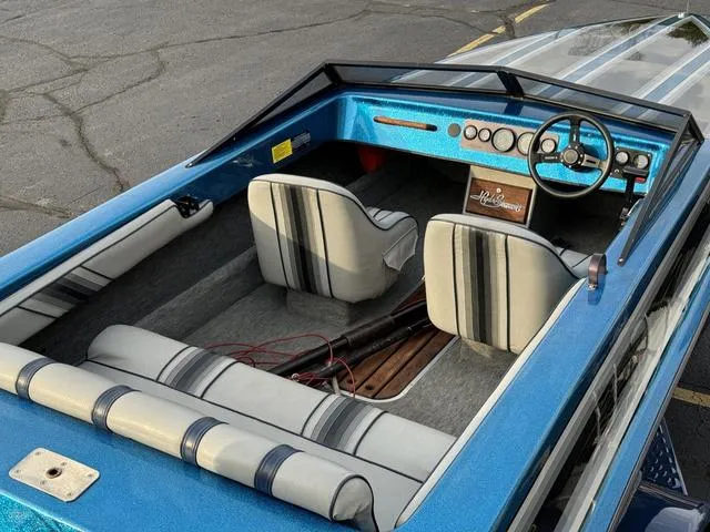 Slide: The Image of 1989 Hydrostream Vegas XT boat interior with blue and white seating and dashboard. - 10