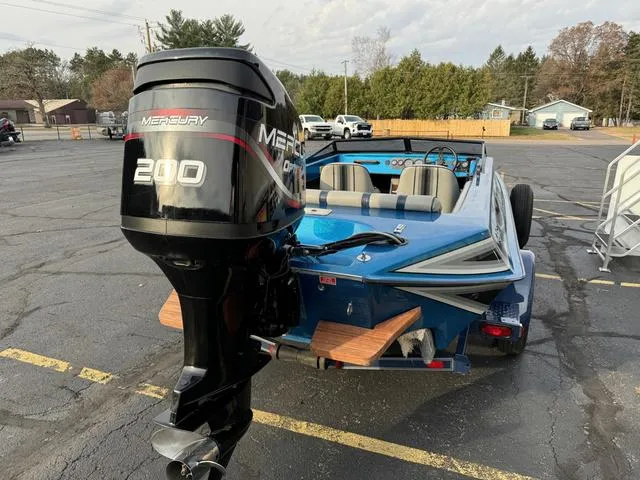 Slide: The Image of 1989 Hydrostream Vegas XT boat with Mercury 200 outboard motor in parking lot. - 11