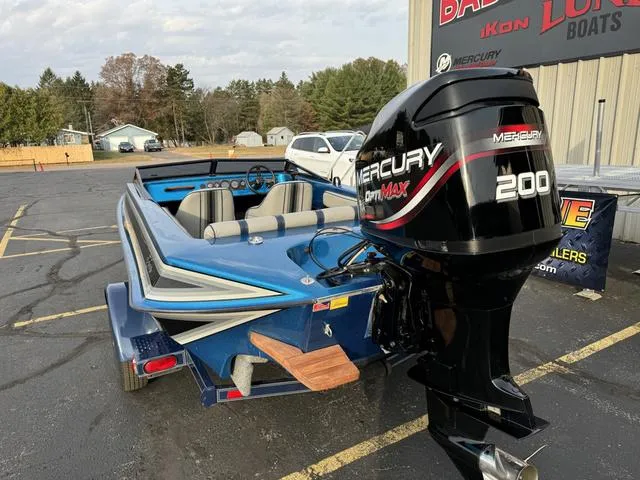 Slide: The Image of 1989 Hydrostream Vegas XT boat with Mercury 200 engine, parked outdoors. - 12