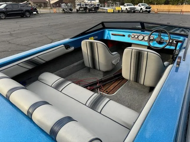 Slide: The Image of 1989 Hydrostream Vegas XT boat interior with blue and gray seating and dashboard. - 17