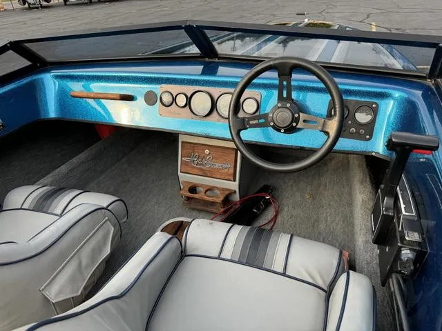 Slide: The Image of 1989 Hydrostream Vegas XT boat interior with blue dashboard and steering wheel. - 18