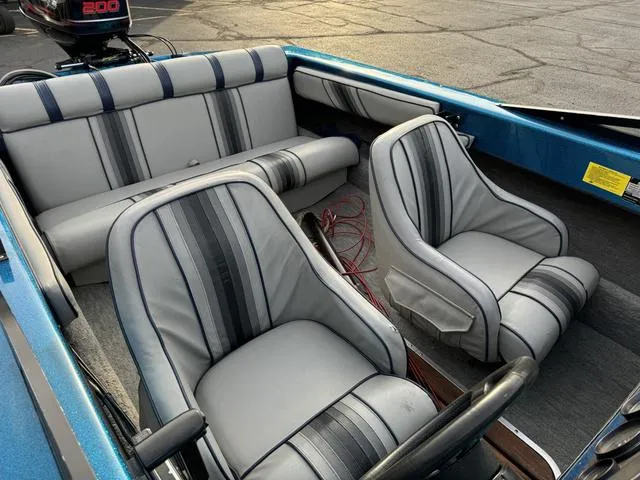 Slide: The Image of 1989 Hydrostream Vegas XT boat interior with gray and blue striped seats. - 23