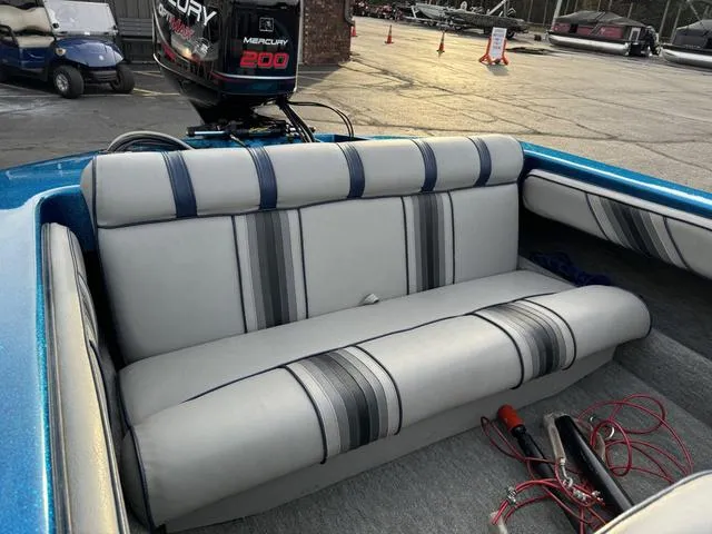 Slide: The Image of 1989 Hydrostream Vegas XT boat interior with striped seating and Mercury 200 outboard motor. - 24
