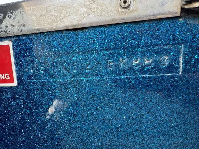 Slide: The Image of 1989 Hydrostream Vegas XT boat hull with blue glitter finish and visible serial number. - 25