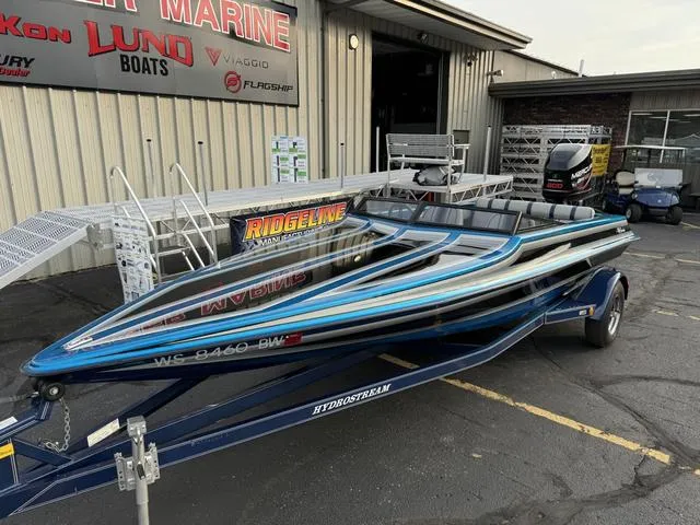 Slide: The Image of 1989 Hydrostream Vegas XT speedboat on trailer outside marine shop. - 3