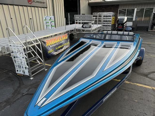 Slide: The Image of 1989 Hydrostream Vegas XT speedboat in blue, parked near aluminum docks. - 4