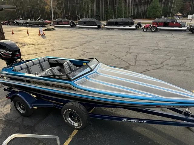 Slide: The Image of 1989 Hydrostream Vegas XT speedboat with sleek design and blue accents on a trailer. - 7