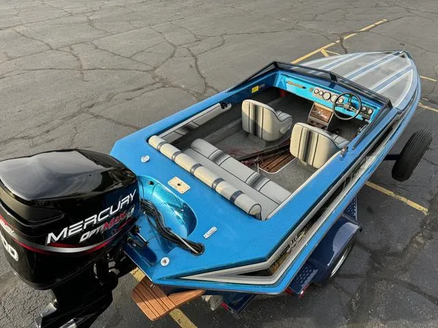 Slide: The Image of 1989 Hydrostream Vegas XT boat with Mercury outboard motor, blue interior, and striped seats. - 9