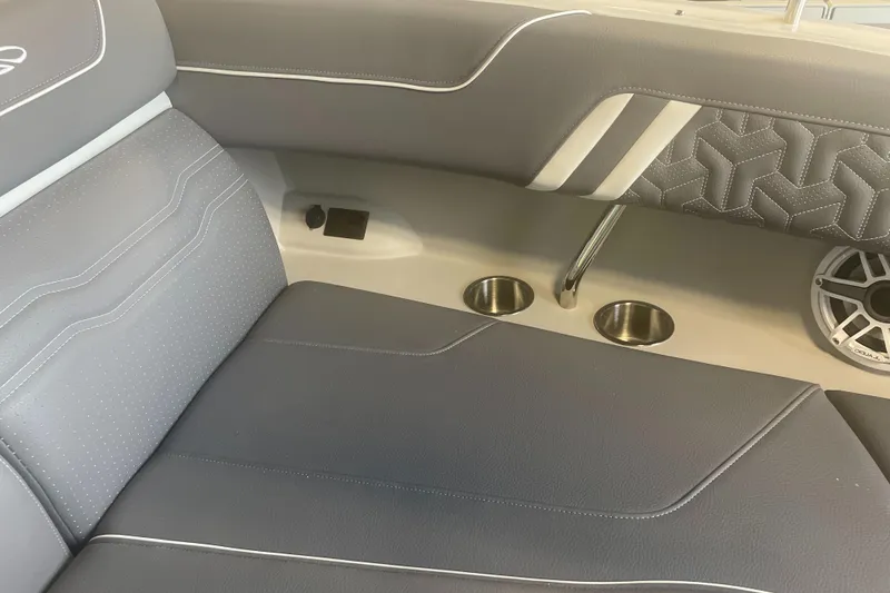 Slide: The Image of 2025 Regal LS9 boat interior with gray seating, cup holders, and speaker. - 13