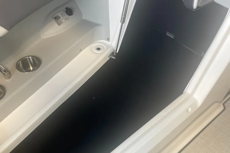 Slide: The Image of 2025 Regal LS9 boat storage compartment with cup holders and sleek design. - 16