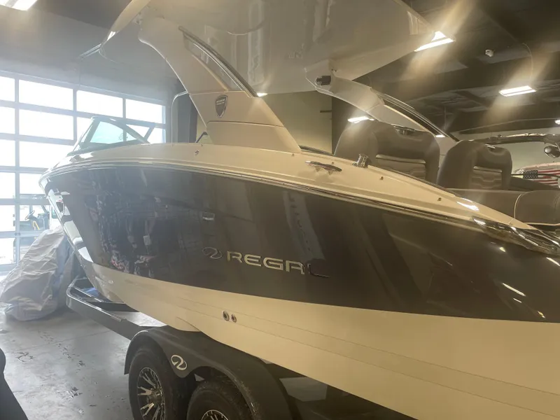 Slide: The Image of 2025 Regal LS9 boat in showroom, sleek design, on trailer. - 2