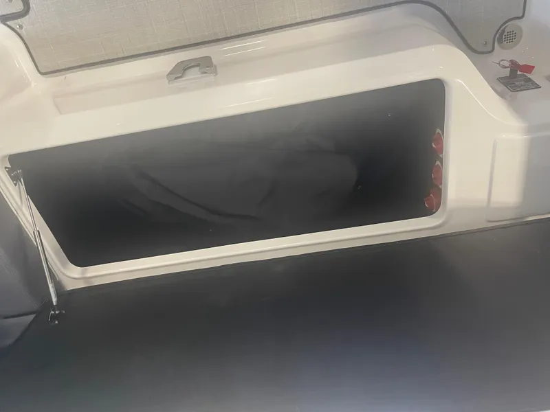 Slide: The Image of 2025 Regal LS9 boat storage compartment with open hatch. - 8