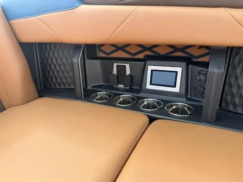 Slide: The Image of 2025 Malibu M230 boat seat with tan and blue upholstery, diamond stitching detail. - 14