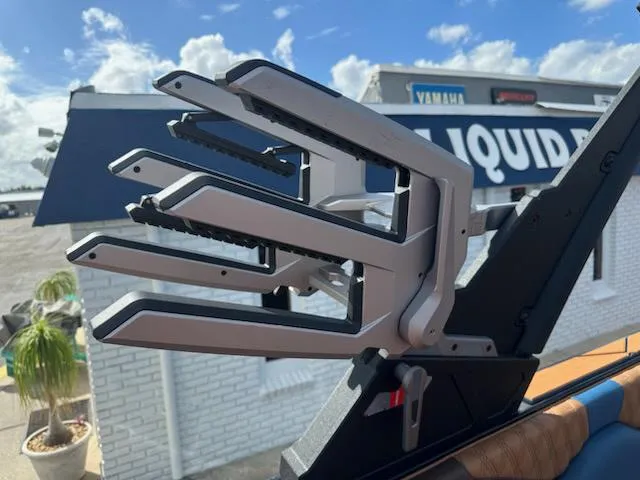 Slide: The Image of 2025 Malibu M230 boat wakeboard rack against a sunny sky backdrop. - 20