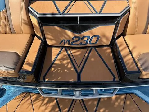 Slide: The Image of 2025 Malibu M230 boat interior with tan and black geometric design. - 27