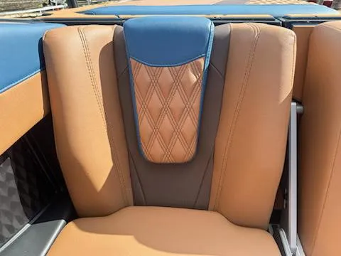 Slide: The Image of 2025 Malibu M230 boat interior with tan and blue leather seats. - 40
