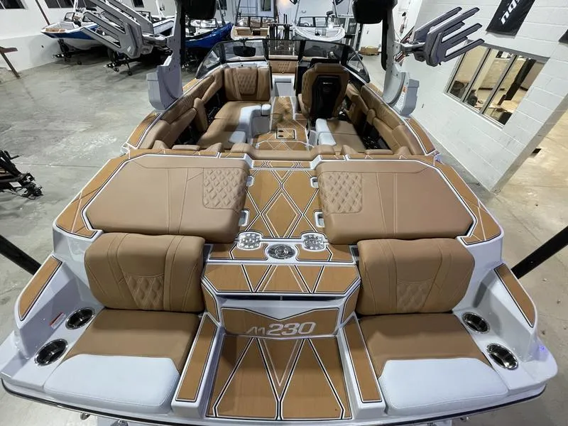 Slide: The Image of Luxurious interior of 2025 Malibu M230 boat with tan upholstery and modern design. - 10