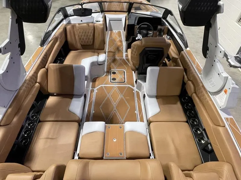 Slide: The Image of Luxurious interior of 2025 Malibu M230 boat with tan leather seating and modern design. - 13