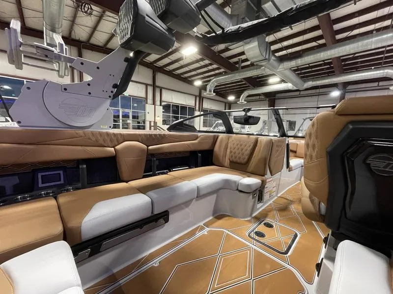 Slide: The Image of Luxurious interior of 2025 Malibu M230 boat with tan and white seating. - 18