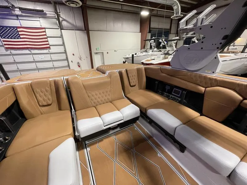 Slide: The Image of Luxurious interior of 2025 Malibu M230 boat with tan and white seating. - 22