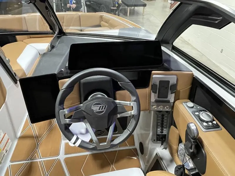 Slide: The Image of 2025 Malibu M230 boat interior with modern dashboard and steering wheel design. - 24