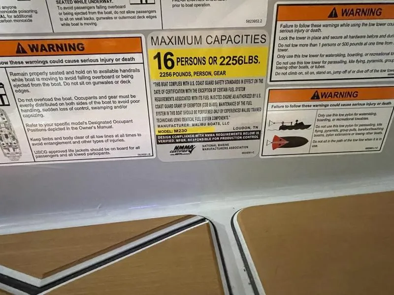 Slide: The Image of Warning labels and capacity information for Malibu M230, 2025 model, indicating 16 persons or 2256 lbs. - 26