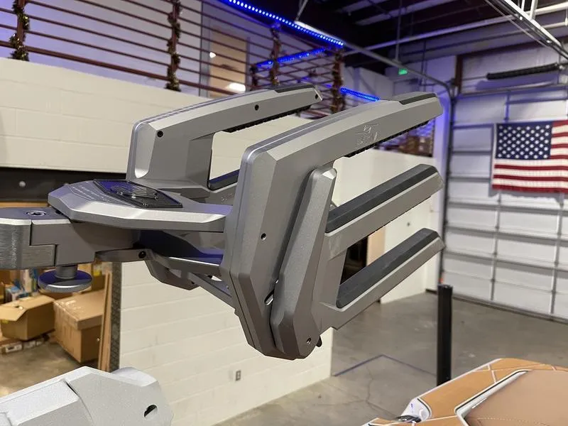 Slide: The Image of 2025 Malibu M230 boat accessory in a warehouse setting with American flag. - 3