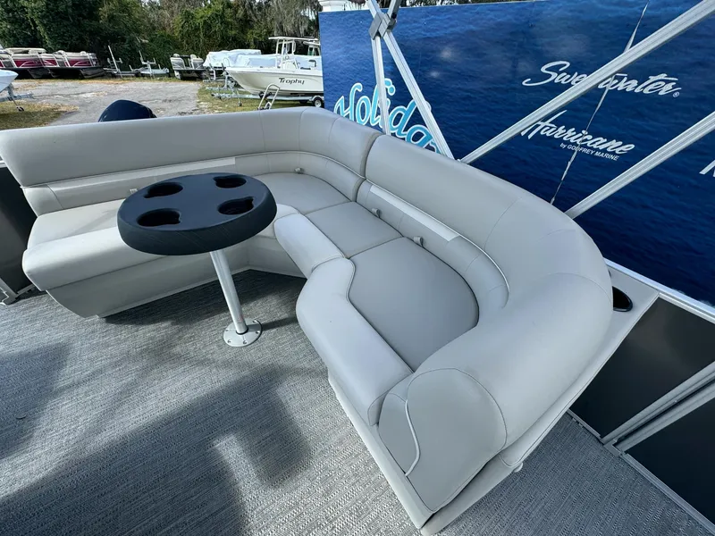 Slide: The Image of Luxurious seating on 2025 Sweetwater 1886 CX pontoon boat with cupholder table. - 3