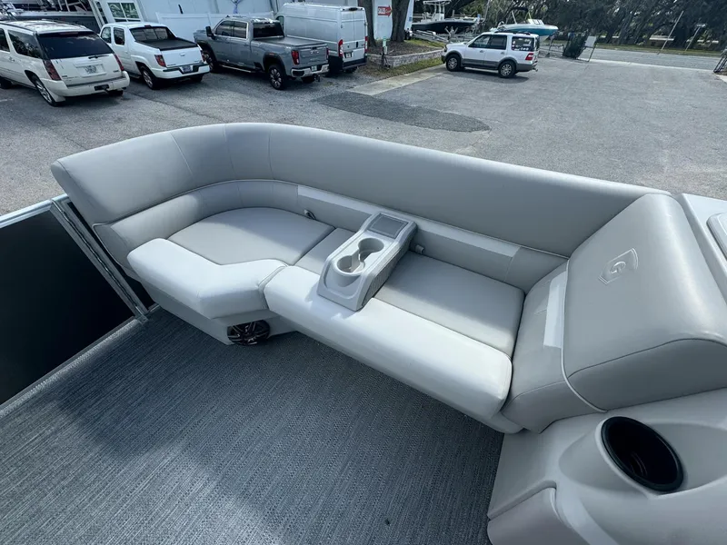 Slide: The Image of 2025 Sweetwater 1886 CX boat interior with gray seating and cup holders. - 5