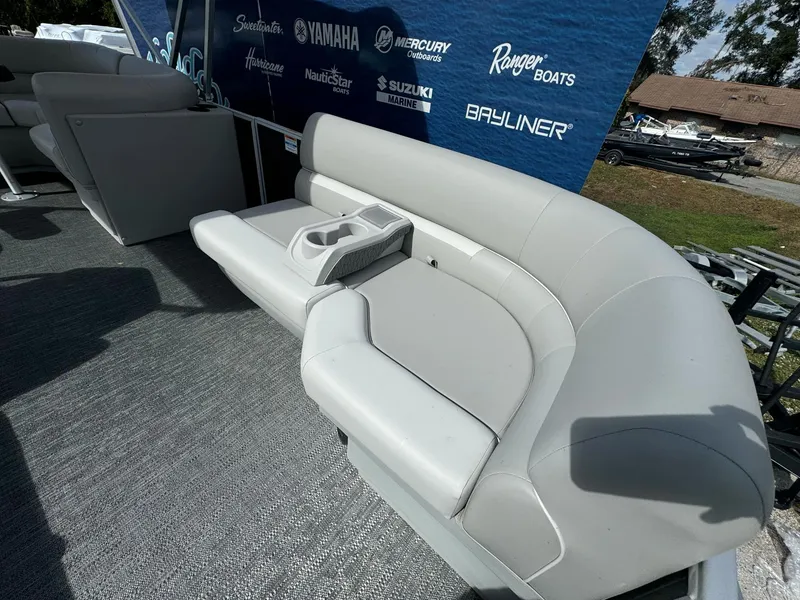 Slide: The Image of Sweetwater 1886 CX 2025 boat interior with gray seating and cup holders. - 6