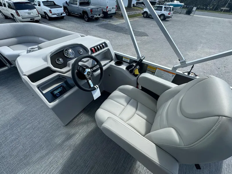 Slide: The Image of 2025 Sweetwater 1886 CX boat interior with steering wheel and comfortable seating. - 8