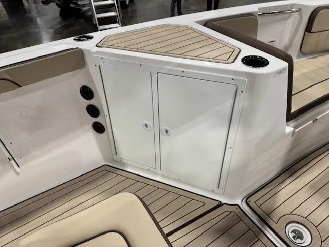 Slide: The Image of 2025 Yamaha Boats 222 FSH Sport E interior with sleek seating and storage compartments. - 10