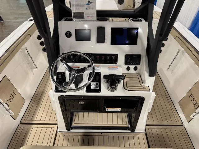 Slide: The Image of 2025 Yamaha Boats 222 FSH Sport E dashboard with steering wheel and controls. - 13