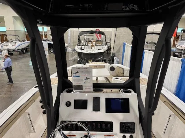 Slide: The Image of 2025 Yamaha Boats 222 FSH Sport E dashboard at a boat show display. - 14