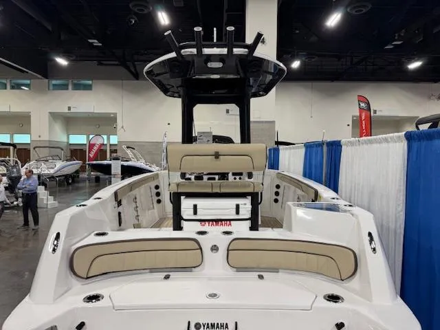 Slide: The Image of 2025 Yamaha Boats 222 FSH Sport E displayed at an indoor boat show. - 2