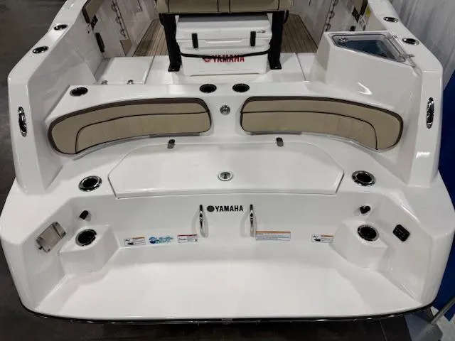 Slide: The Image of 2025 Yamaha Boats 222 FSH Sport E, rear view with seating and cup holders. - 20