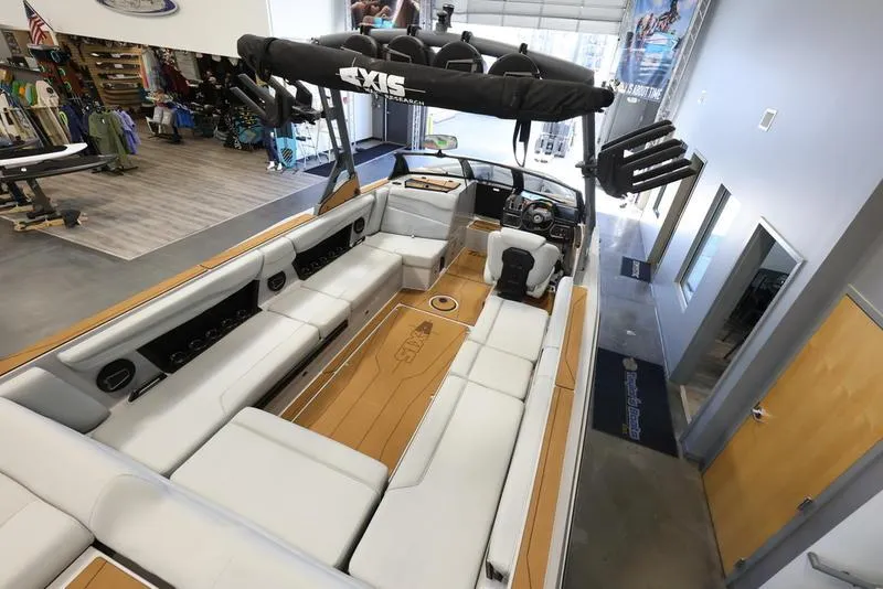 Slide: The Image of 2024 Axis T250 boat interior with spacious seating and modern design in showroom. - 10
