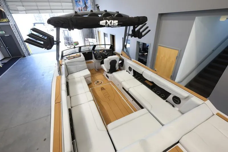 Slide: The Image of 2024 Axis T250 boat interior with white seating and modern dashboard. - 11