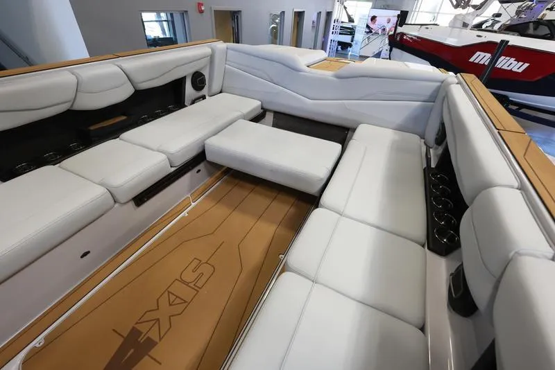 Slide: The Image of 2024 Axis T250 boat interior with white seating and wood flooring. - 17