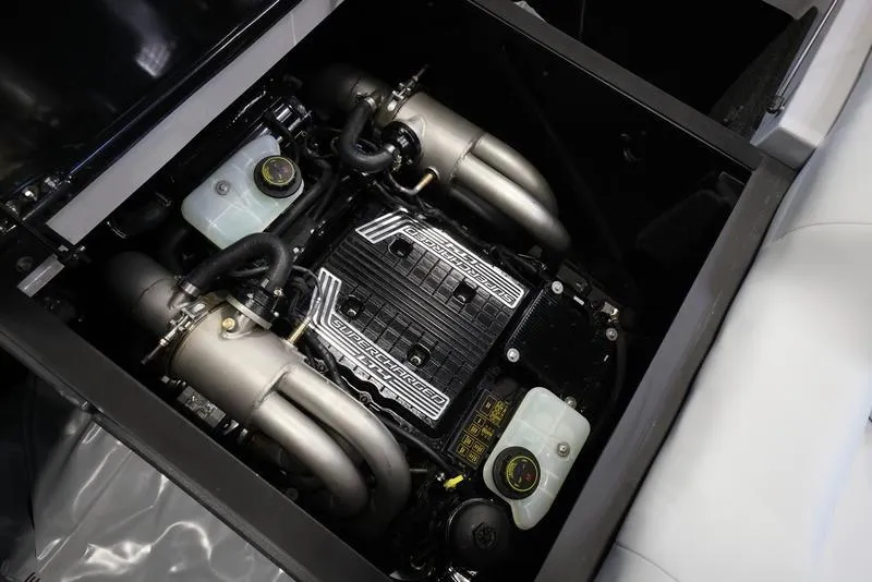 Slide: The Image of 2024 Axis T250 engine compartment with dual exhaust pipes and fluid reservoirs. - 21