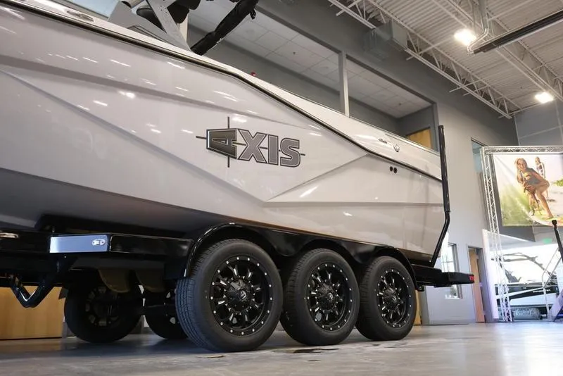 Slide: The Image of 2024 Axis T250 boat on triple-axle trailer in showroom. - 4