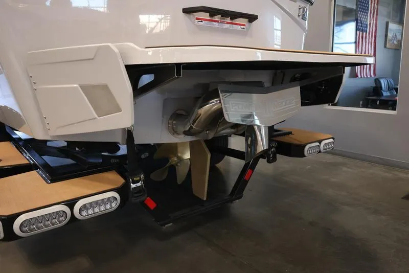 Slide: The Image of 2024 Axis T250 boat stern with propeller and exhaust system in showroom. - 5