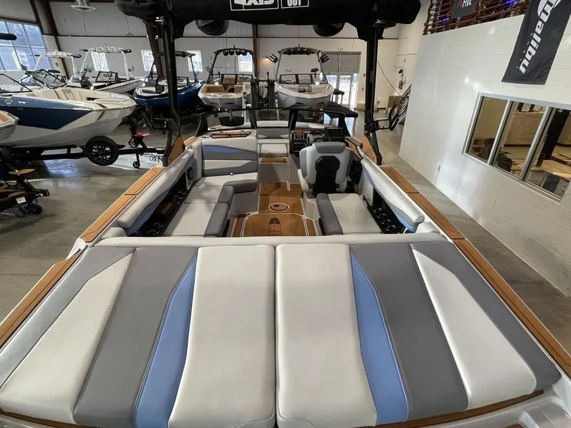 Slide: The Image of 2025 Axis A225 boat interior with spacious seating in a showroom. - 10