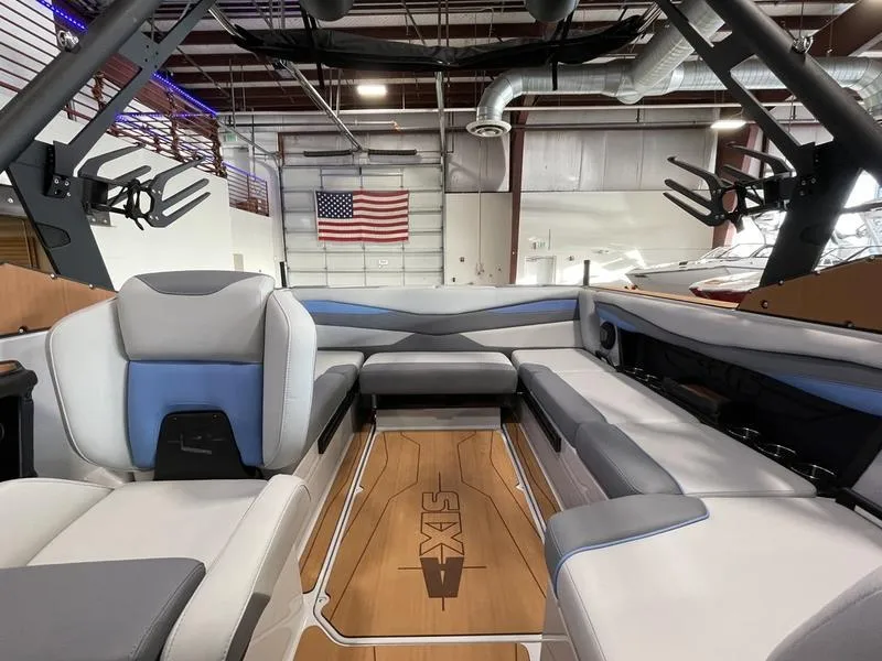 Slide: The Image of Interior of 2025 Axis A225 boat with modern seating and American flag in background. - 18